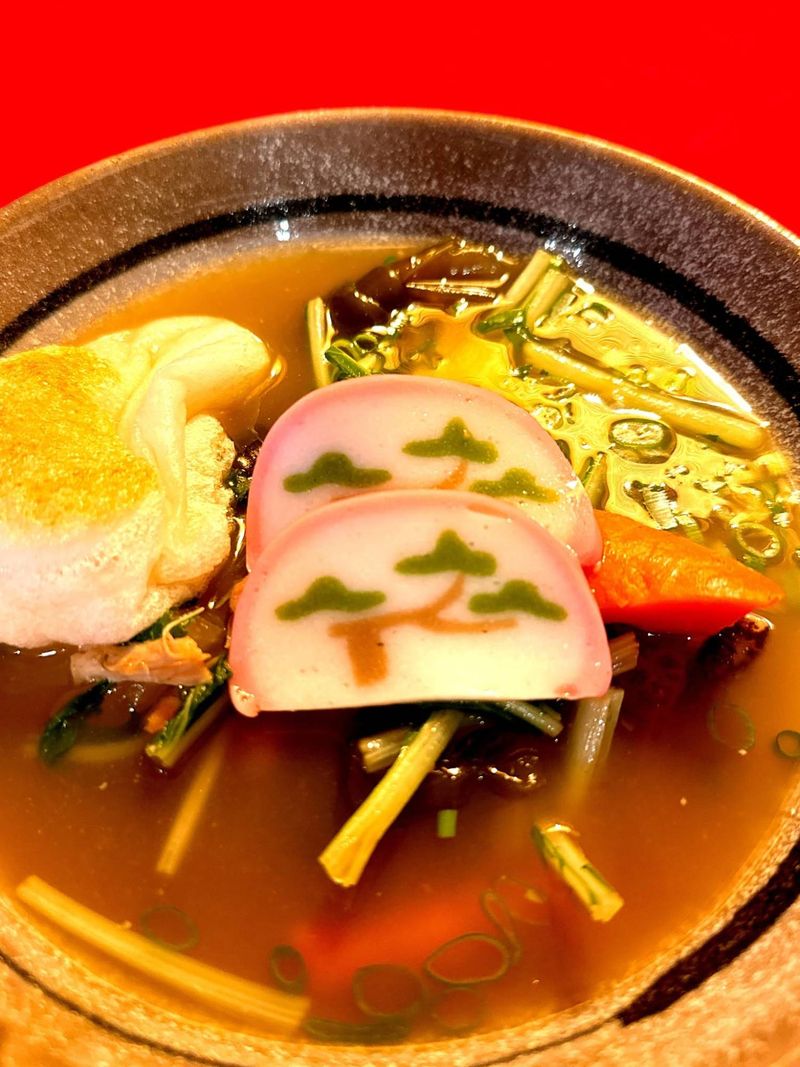 Japanese New Year ozoni soup with kamaboko and greens